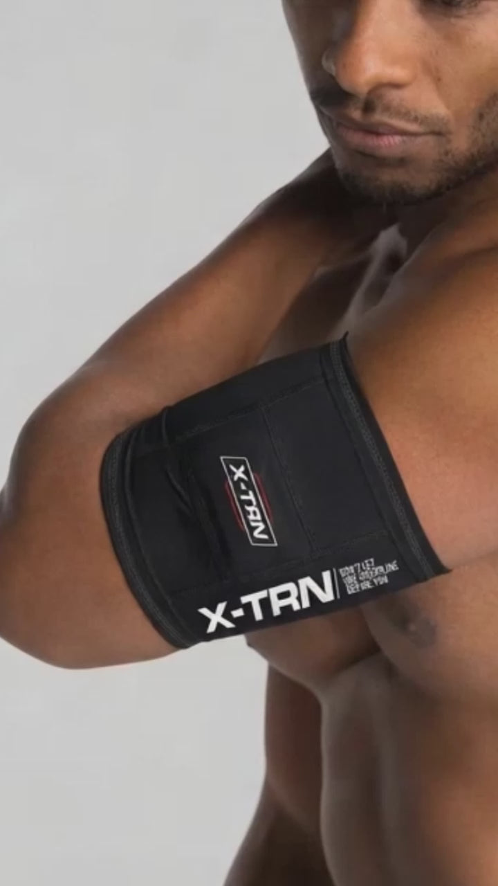 X-TRN arm bond compression support worn during workout for improved performance and arm stability